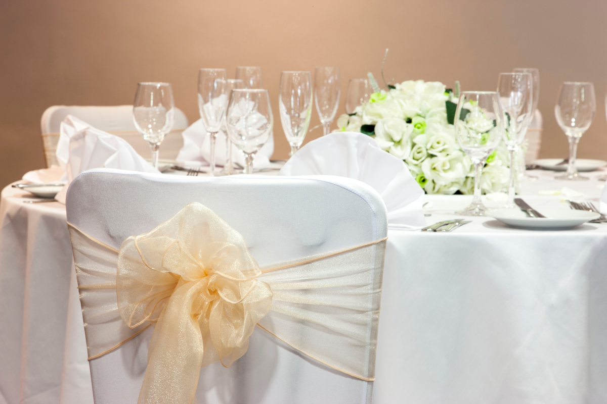 bride and groom placing ring on fingers.